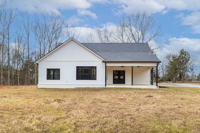 modern farmhouse featuring a ceiling fan, french doors, a shingled roof, and a front lawn