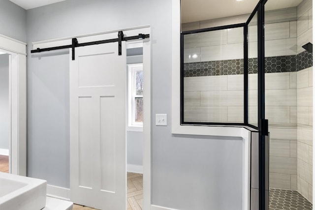 full bathroom featuring a stall shower and baseboards