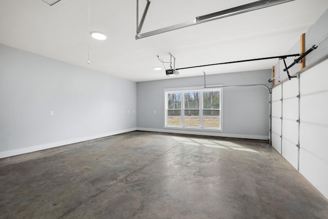 garage with baseboards and a garage door opener