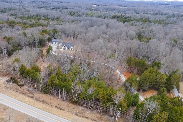 drone / aerial view featuring a wooded view