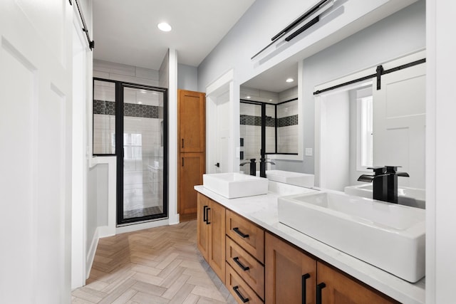 bathroom with recessed lighting, a sink, and a shower stall