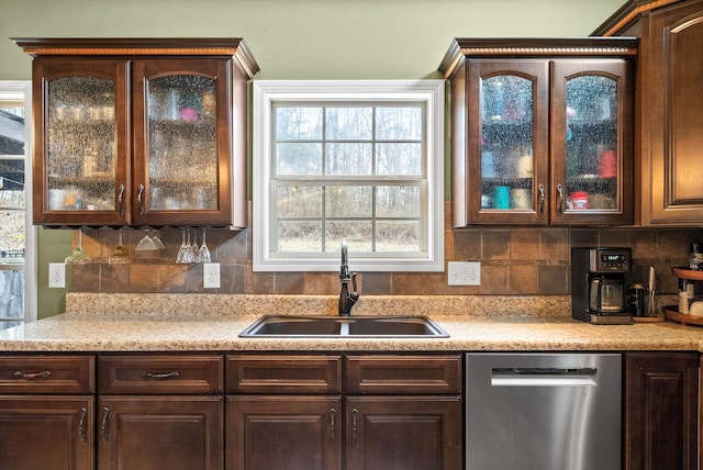 kitchen with decorative backsplash, dishwasher, sink, and dark brown cabinets