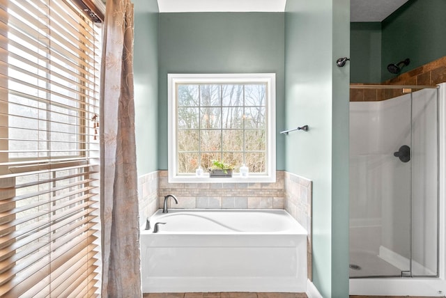 bathroom featuring separate shower and tub