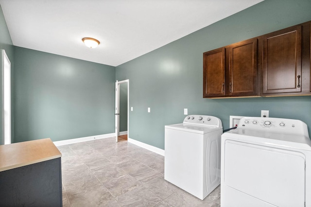 laundry room featuring cabinets and washing machine and clothes dryer