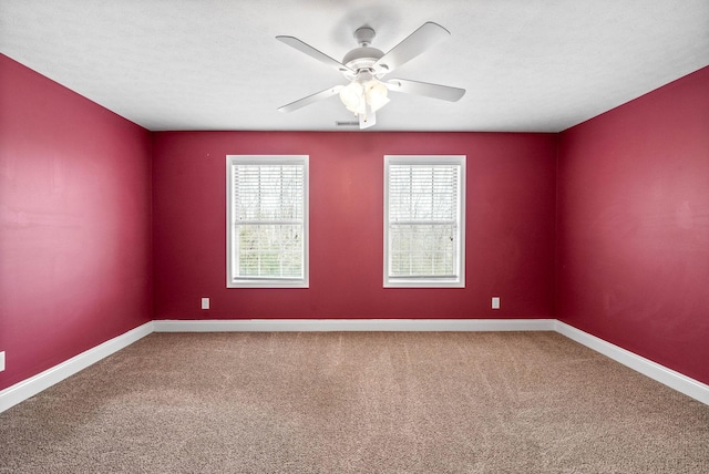 spare room with a textured ceiling, ceiling fan, and carpet flooring