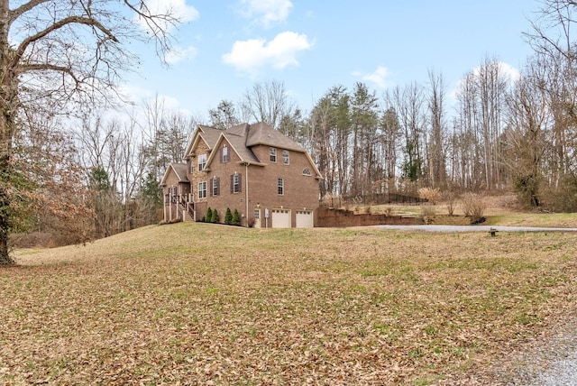 view of home's exterior featuring a garage and a yard