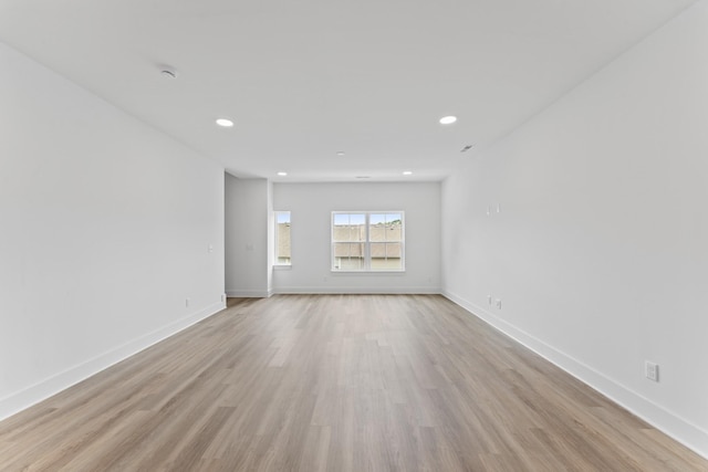 spare room with recessed lighting, light wood-style flooring, and baseboards