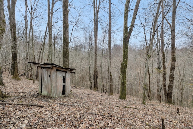 view of shed featuring a forest view