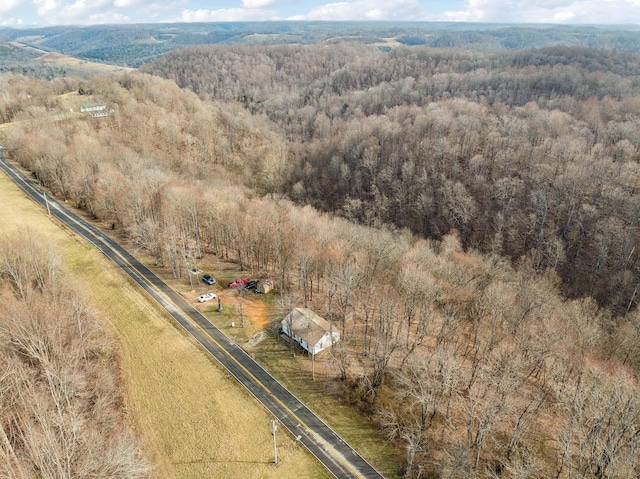 aerial view featuring a rural view and a wooded view