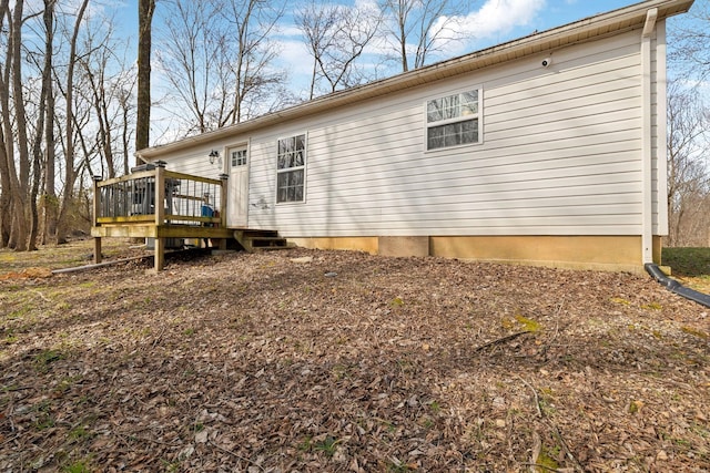 rear view of house with a wooden deck