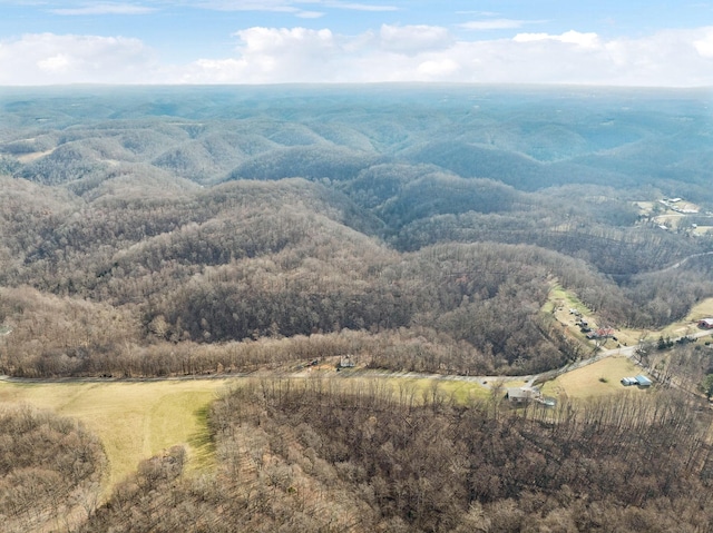 drone / aerial view with a wooded view