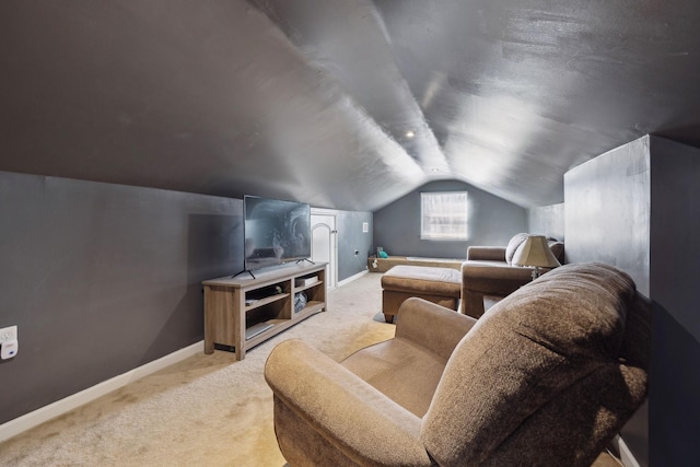 home theater room with carpet floors, baseboards, and vaulted ceiling