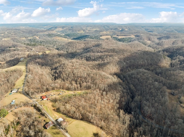 drone / aerial view featuring a forest view