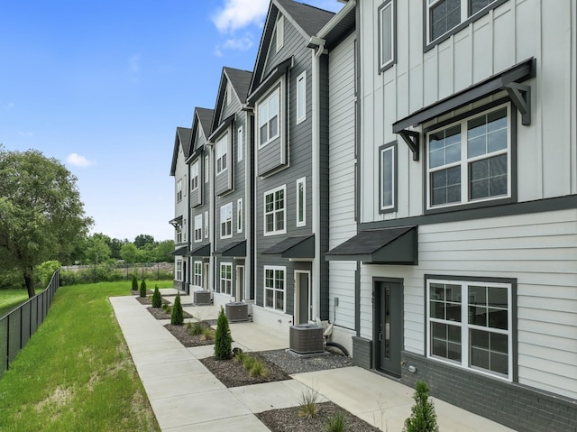 surrounding community featuring a patio, a lawn, and fence