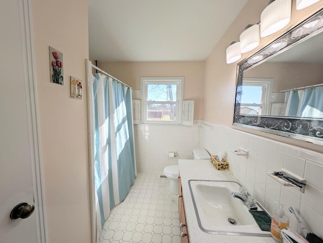 bathroom featuring toilet, tile walls, curtained shower, and vanity