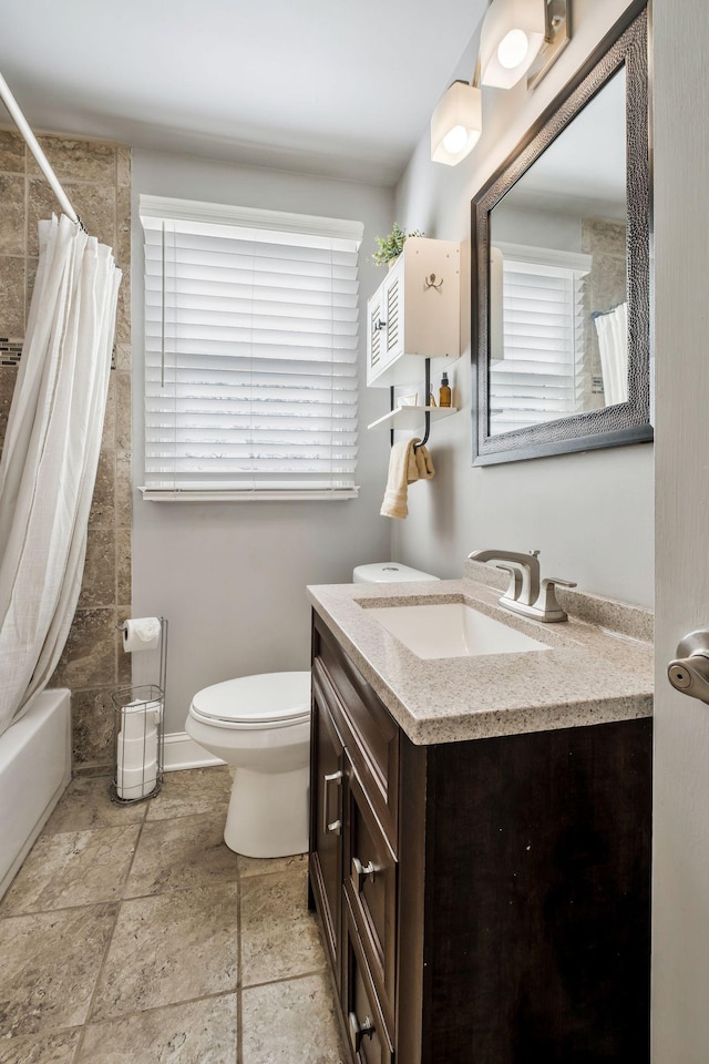 full bathroom with toilet, a healthy amount of sunlight, vanity, and shower / tub combo