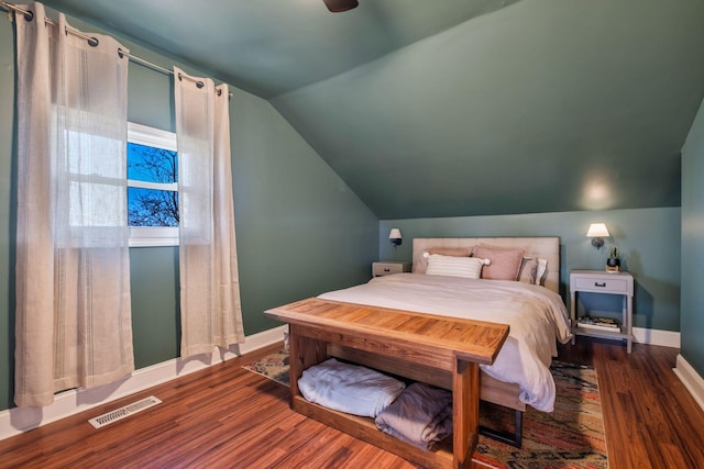 bedroom with lofted ceiling and dark hardwood / wood-style flooring