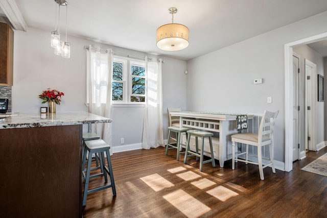 dining area featuring dark hardwood / wood-style floors