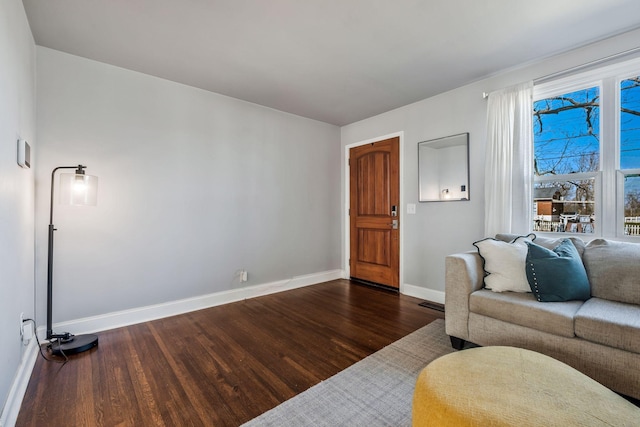 living room with dark hardwood / wood-style flooring