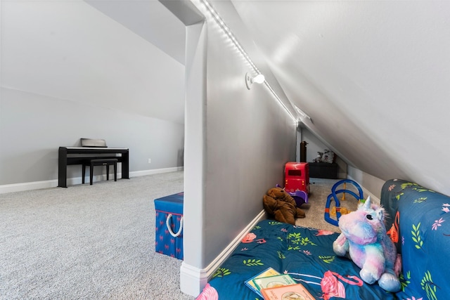 rec room featuring vaulted ceiling and carpet