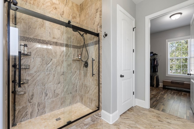 bathroom featuring a shower with shower door