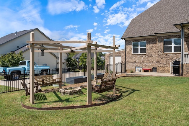 view of yard with a pergola and a fire pit