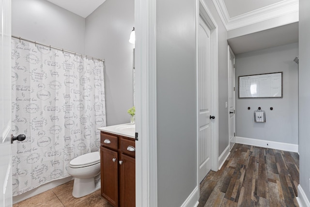 bathroom with vanity, crown molding, toilet, and hardwood / wood-style floors