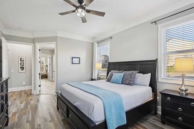 bedroom featuring ceiling fan, wood-type flooring, and ornamental molding