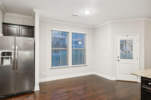 unfurnished dining area with crown molding and dark hardwood / wood-style floors