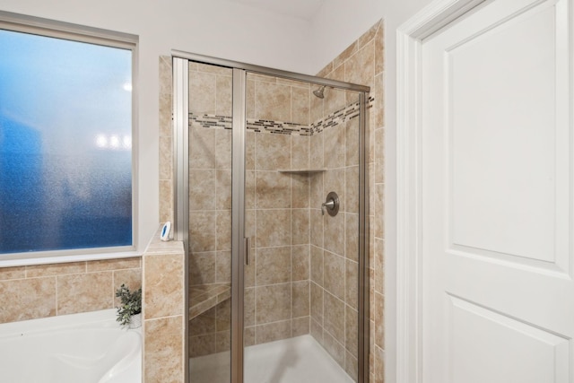 bathroom featuring separate shower and tub