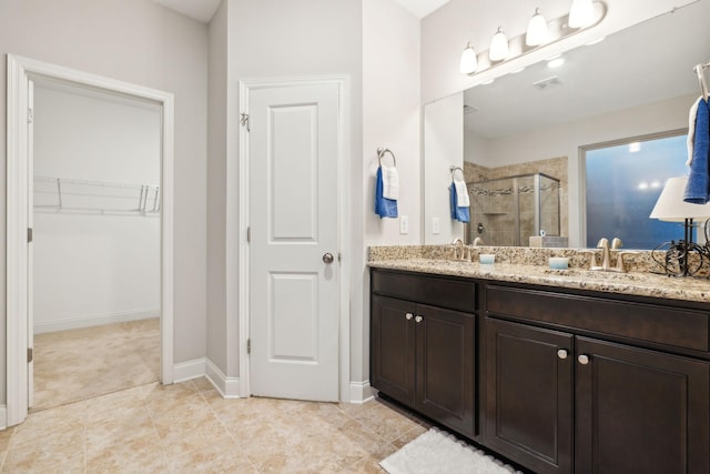 bathroom with tile patterned floors, vanity, and an enclosed shower