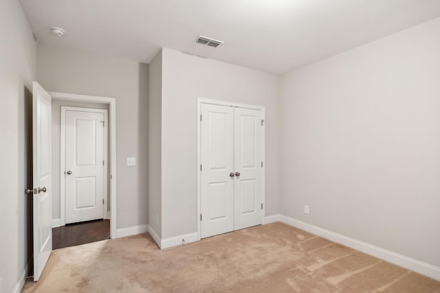 unfurnished bedroom featuring carpet and a closet