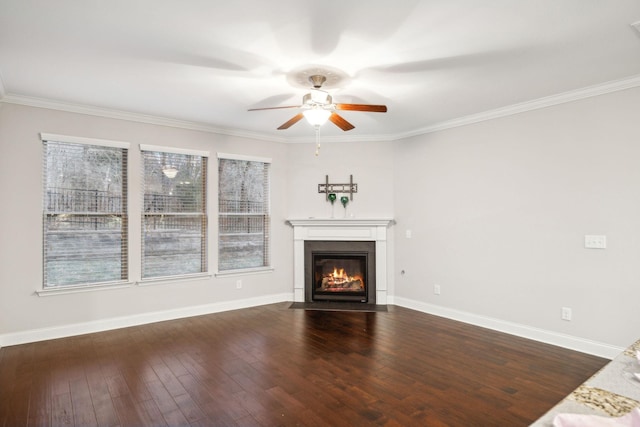 unfurnished living room featuring ceiling fan, ornamental molding, and dark wood-type flooring