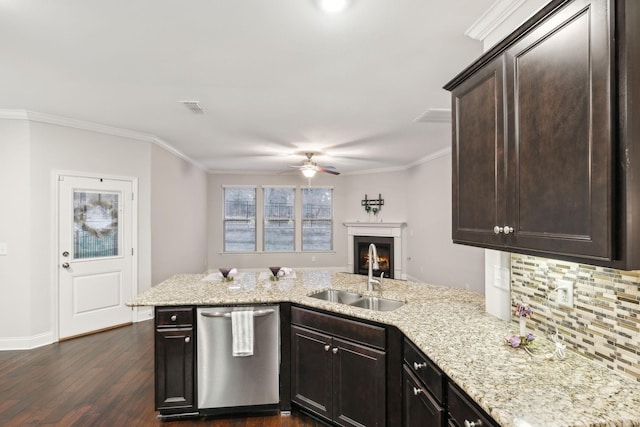 kitchen with dark brown cabinetry, stainless steel dishwasher, ornamental molding, sink, and kitchen peninsula