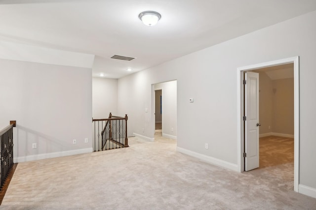 unfurnished room featuring light carpet