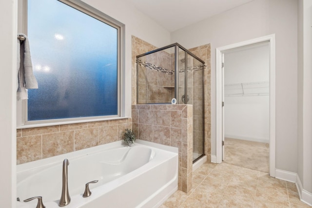 bathroom featuring tile patterned flooring and shower with separate bathtub