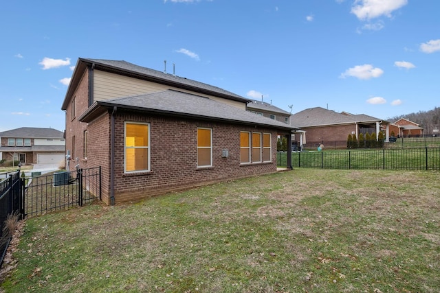 back of house with a lawn