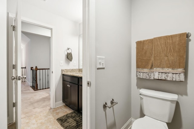 bathroom with vanity, tile patterned flooring, and toilet