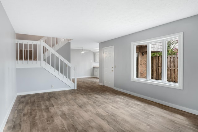 214 Cedarwood Ln Unit 214, Madison, TN 37115 - unfurnished living room with wood finished floors, stairway, and a ceiling fan
