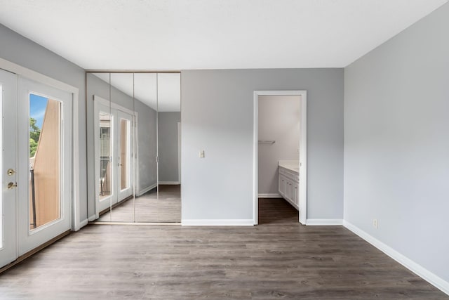 214 Cedarwood Ln Unit 214, Madison, TN 37115 - unfurnished bedroom featuring access to exterior, wood finished floors, french doors, and connected bathroom