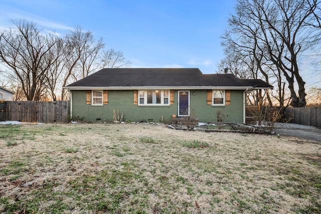 ranch-style house with brick siding, a chimney, crawl space, fence, and a front lawn