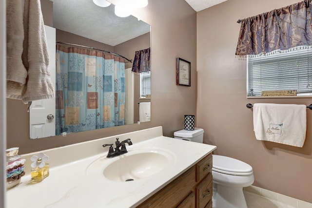 bathroom featuring toilet, a textured ceiling, vanity, curtained shower, and tile patterned flooring