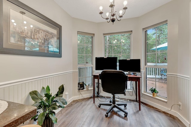 office area with hardwood / wood-style flooring, a notable chandelier, and a textured ceiling