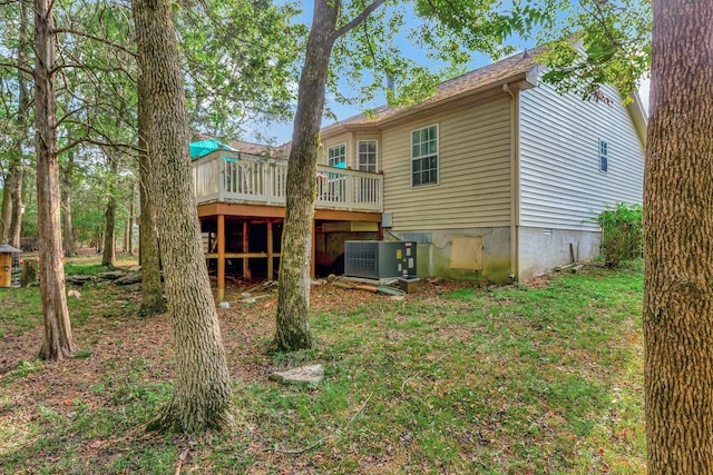 rear view of property with cooling unit and a deck