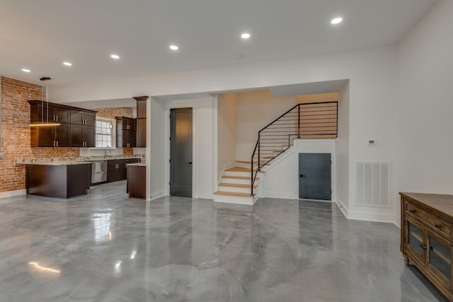 unfurnished living room with brick wall