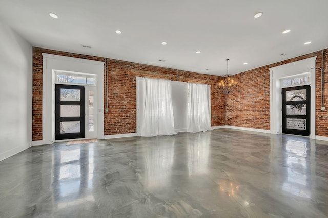 entrance foyer featuring plenty of natural light and brick wall