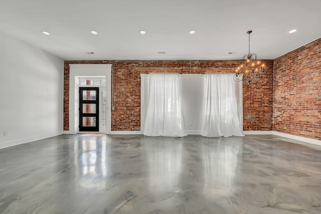 empty room featuring brick wall, recessed lighting, and baseboards