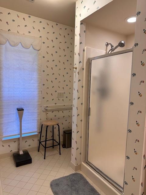 bathroom with tile patterned floors and walk in shower