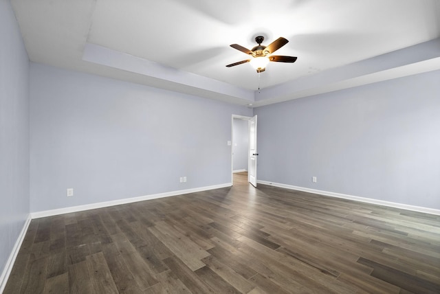 empty room featuring ceiling fan and dark wood-type flooring