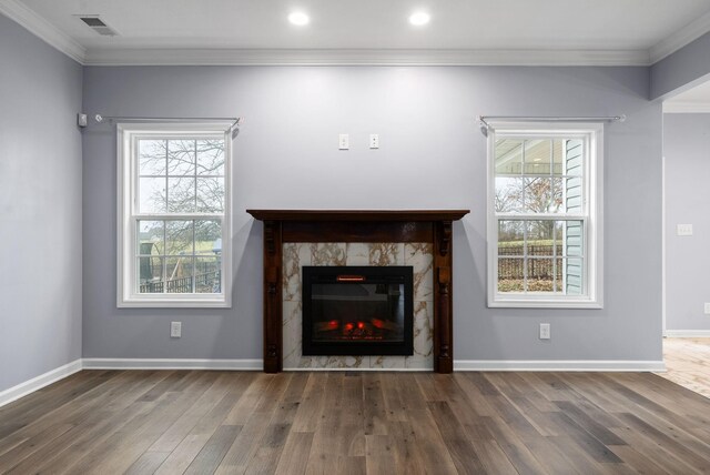 unfurnished living room featuring ornamental molding and dark hardwood / wood-style floors